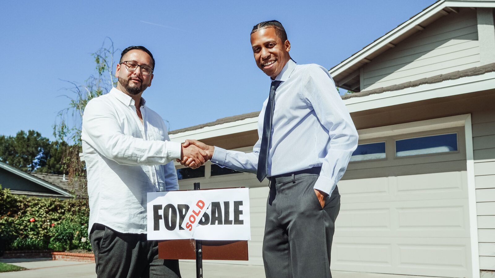 Homeowner and agent shaking hands after a successful home sale